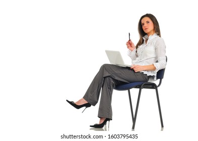 Beautiful Woman Sits On Chair With White Laptop In Lap And A Pen In Hand. Photo On Light Background