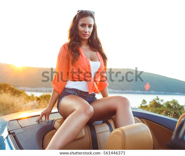 Beautiful woman\
sitting in cabriolet, enjoying trip on luxury modern car with open\
roof, fashionable lifestyle\
concept