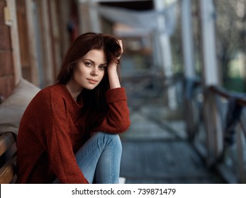 beautiful woman sitting on a bench on the veranda resting, style, fashion