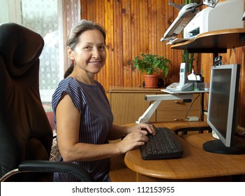 Beautiful Woman Sitting On Black Chair Of The Computer