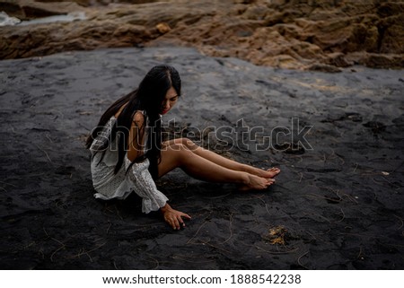 Similar – beautiful brunette short hair girl leaning on gray rock wall outdoors smiling happy