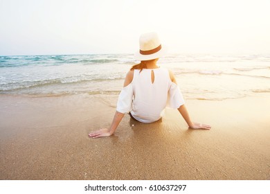 beautiful woman sitting on sand beach. soft focus - Shutterstock ID 610637297