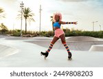 Beautiful woman skating with roller skates and having fun. Professional skater and dancer training in the morning wearing colored and fashionable clothes.