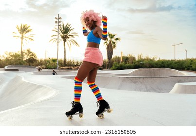 Beautiful woman skating with roller skates and having fun. Professional skater and dancer training in the morning wearing colored and fashionable clothes.