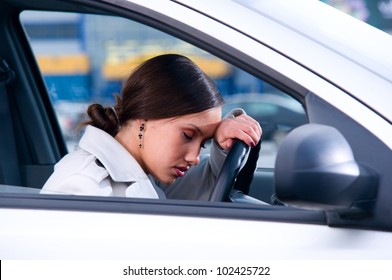 beautiful woman is sleeping in a car