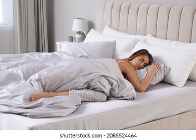 Beautiful woman sleeping in comfortable bed with silky linens - Shutterstock ID 2085524464