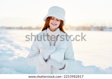 beautiful woman smile Winter mood walk white coat snow in the hands nature