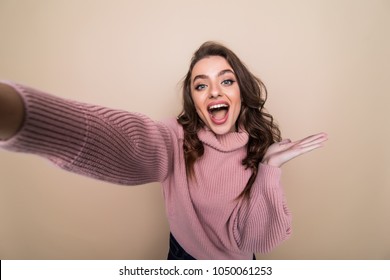 Beautiful Woman Smiling With White Teeth And Making Selfie, Photographing Herself Over Brown