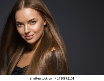 Beautiful woman smooth long hair brunette natural make up tanned skin beautiful female portrait over dark background