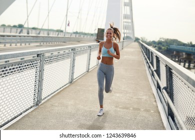 Beautiful Woman In Sportswear Running Outside On The Street Fast