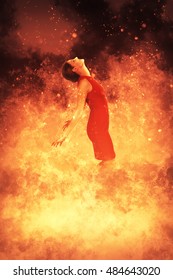 Beautiful woman standing in the midst of a fire
