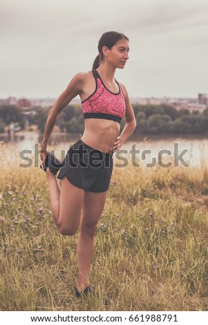 Similar – Fit muscular woman working out in a park