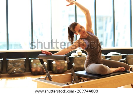 Beautiful woman is stretching her upper side of the body