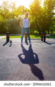 Beautiful Woman Stretching In The Park Pre Workout In Front Of Lush Green Leafy Trees