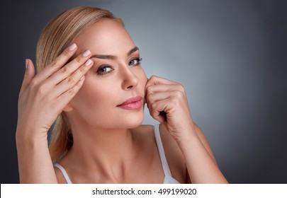 
Beautiful Woman In The Struggle With Traces Of Aging, Wrinkles