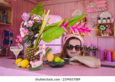 Beautiful Woman With Sunglasses And A Centerpiece With Tropical Fruits And Flowers. Joy, Exoticism And Color Of Summer