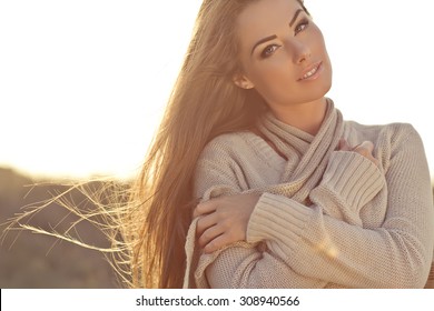 Beautiful Woman In A Sweater In The Fall.Warm Light Sunset