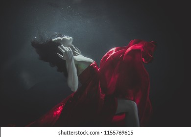 Beautiful Woman Swimming Underwater With Elegant Dress