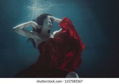 Beautiful Woman Swimming Underwater With Elegant Dress