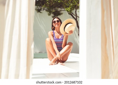 Beautiful Woman In Swimsuit At Backyard Pool At Summer Sunny Day Enjoying Amazing Warm Weather, Catching Sun Rays