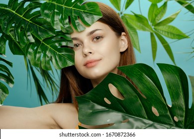 Beautiful woman swimsuit green leaves Exotic tropics pure skin sun