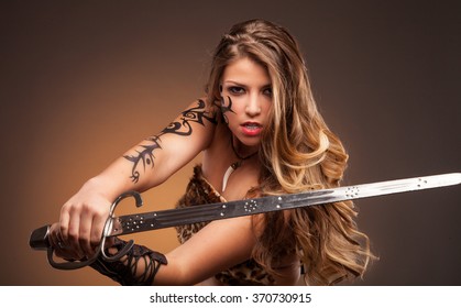 Beautiful woman with sword . Fantasy and legend. Standing in fighting stance.
