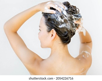 A Beautiful Woman Taking A Shower, Suds And Bubbles In Hair.