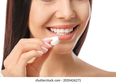 Beautiful Woman Taking Vitamin C Pill On White Background, Closeup