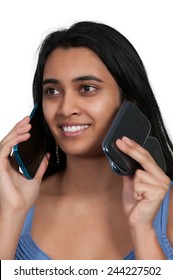 Beautiful Woman Talking And Multitasking While Juggling Multiple Cell Phones And Conversations