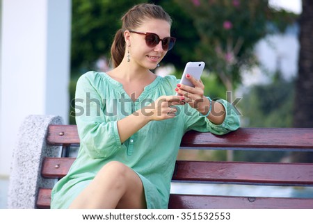 beautiful woman talking on the phone in the park