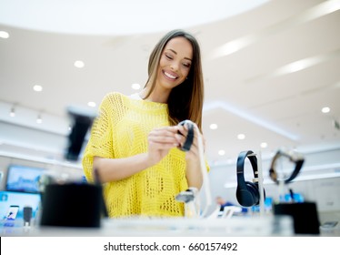 Beautiful Woman In A Tech Store, Exploring New Smart Watch.