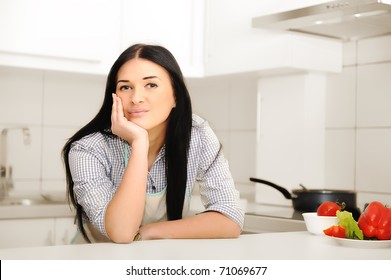 Beautiful woman thinking in kitchen