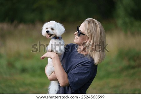 Similar – Image, Stock Photo Blond woman with her two dogs in the countryside