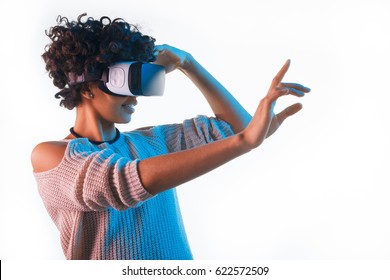 Beautiful woman touching air during the VR experience isolated on white. - Powered by Shutterstock