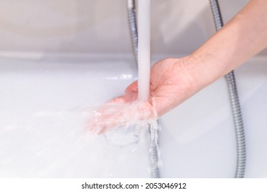 Beautiful Woman Touching On The Surface Of Water In Bathtub To Check The Water Temperature Before Get In The Bath. Wellness And Hydro Therapy Concept.