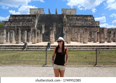 Beautiful Woman Tourist In A Hat Posing Near Mayan Buildings In Chichen Itza Mexico