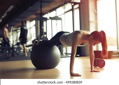 Beautiful woman training pilates in gym