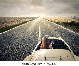 Beautiful Woman Traveling On A Vintage Car