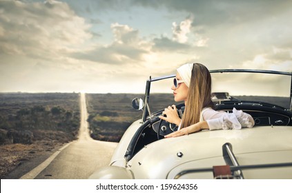 Beautiful Woman Traveling On A Vintage Car