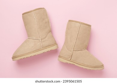 Beautiful woman ugg boots on color background,top view