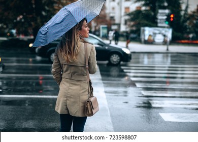 Beautiful woman with umbrella on a rainy day. - Powered by Shutterstock