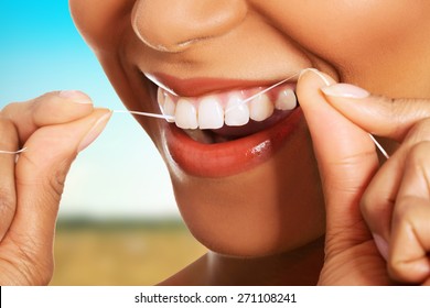 Beautiful Woman Using Dental Floss.