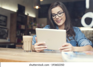 Beautiful Woman Using Digital Tablet At Cafe 