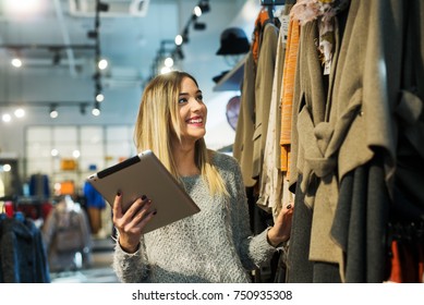 Beautiful woman using a digital tablet in the store.