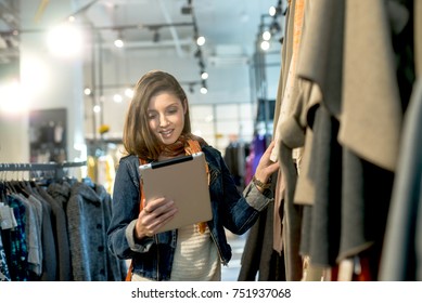 Beautiful woman using a digital tablet in the store.