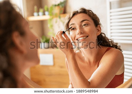 Similar – Image, Stock Photo Smiling young woman using digital tablet outdoors.