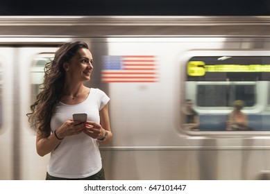 Beautiful Woman Using Phone In The Subway Of New York.