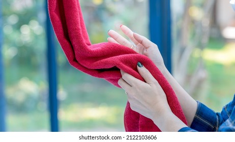 Beautiful Woman  Using Towel For Wiping Hands Dry After Washing In Bathroom . Hygiene And Hand Care