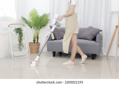 Beautiful Woman Vacuuming The Floor Of Her Living Room, Big Cleaning In The House, Removes Germs And Dirt And Deep Stains, Housewife Cleaning, Keeping Her Home Clean, Domestic Hygiene.