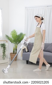 Beautiful Woman Vacuuming The Floor Of Her Living Room, Big Cleaning In The House, Removes Germs And Dirt And Deep Stains, Housewife Cleaning, Keeping Her Home Clean, Domestic Hygiene.